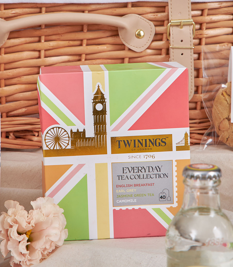 Luxury afternoon tea gift set with English breakfast tea collection, pink flower, artisan biscuits, and London-inspired