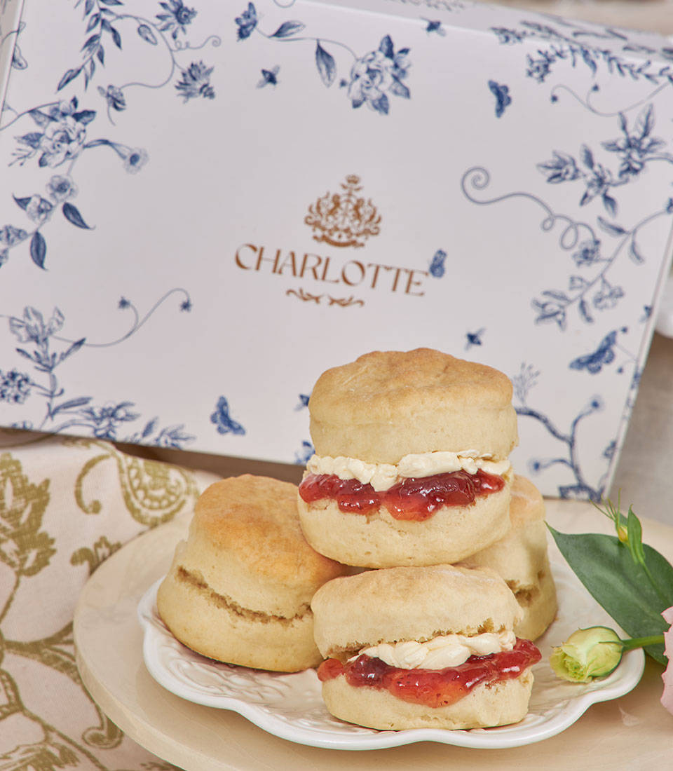 Charlotte Bakery afternoon tea gift set with scones, clotted cream and jam on scalloped plate