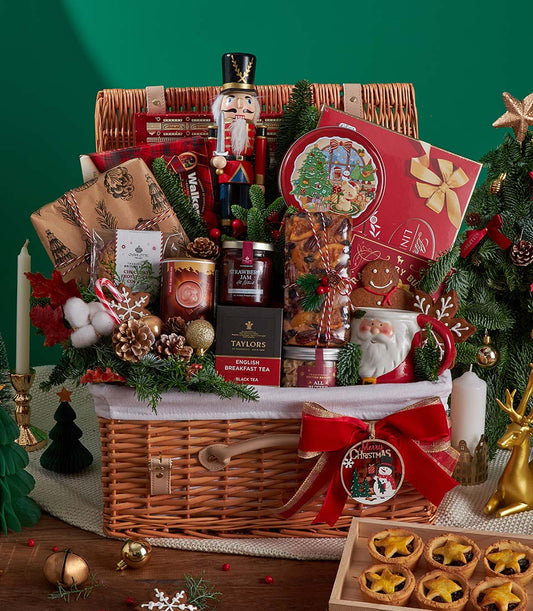 Festive Christmas hamper with gourmet treats, English breakfast tea, nutcracker, and red velvet bow