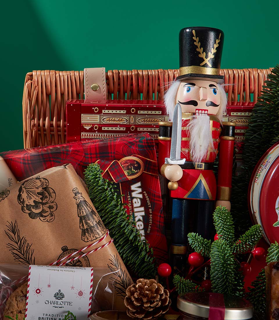 Grand Traditional Christmas gift basket with wooden nutcracker, Scottish treats, Charlotte bakery cookies, and festive pine