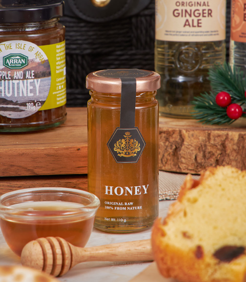 Golden gourmet cheese and artisan condiments hamper with honey, chutney, and ginger ale