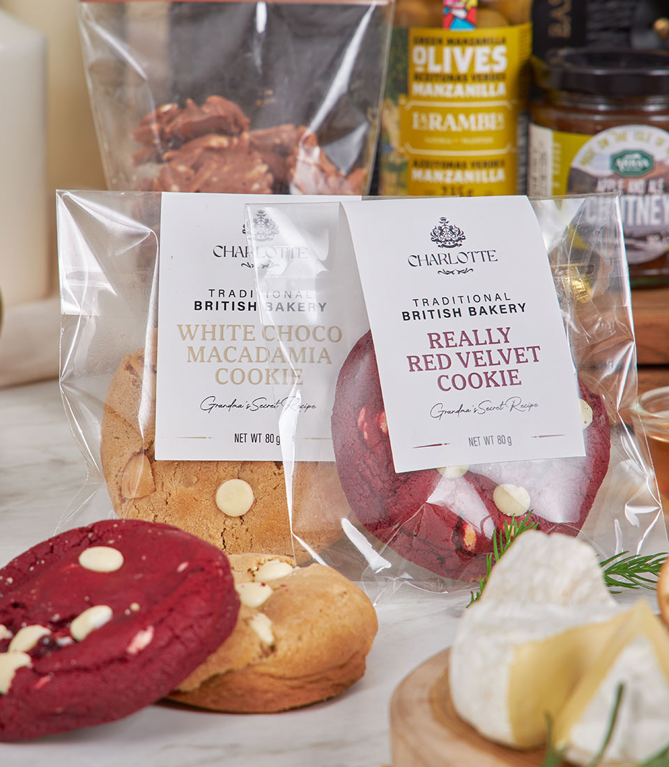 Gourmet cheese and snack hamper with Charlotte Bakery cookies, chocolate clusters, olives, chutney, and artisan cheese
