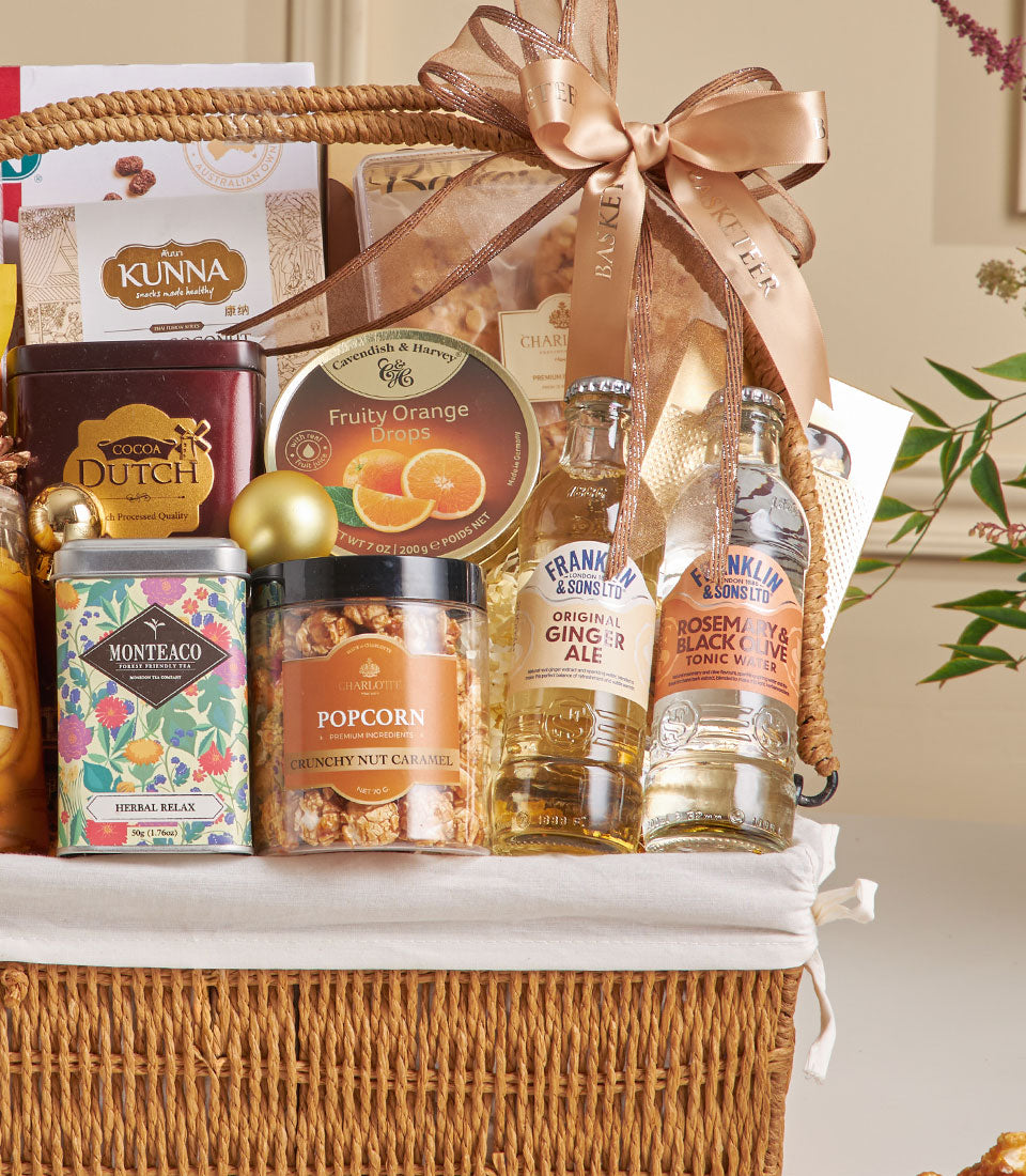 Premium gourmet gift basket with almond cookies, cocoa, herbal tea, and artisan snacks for New Year celebrations