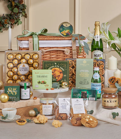 Sage green luxury gift basket with gourmet chocolates, cookies, and sparkling beverages for New Year celebrations