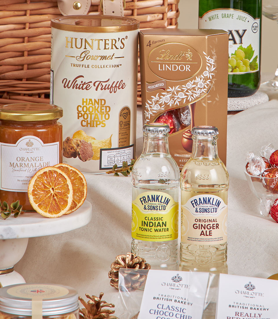 Basketeer premium hamper: Lindt chocolates, truffle chips, marmalade and ginger ale in a woven wicker basket, perfect as a corporate gift in Bangkok.