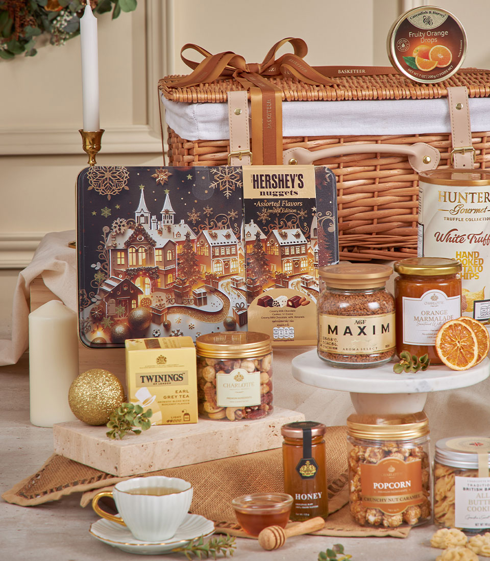 Premium golden gourmet hamper with wicker basket, luxury chocolates, coffee, tea, and artisan treats for New Year gifting