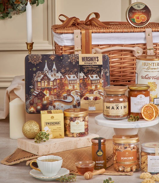 Premium golden gourmet hamper with wicker basket, luxury chocolates, coffee, tea, and artisan treats for New Year gifting