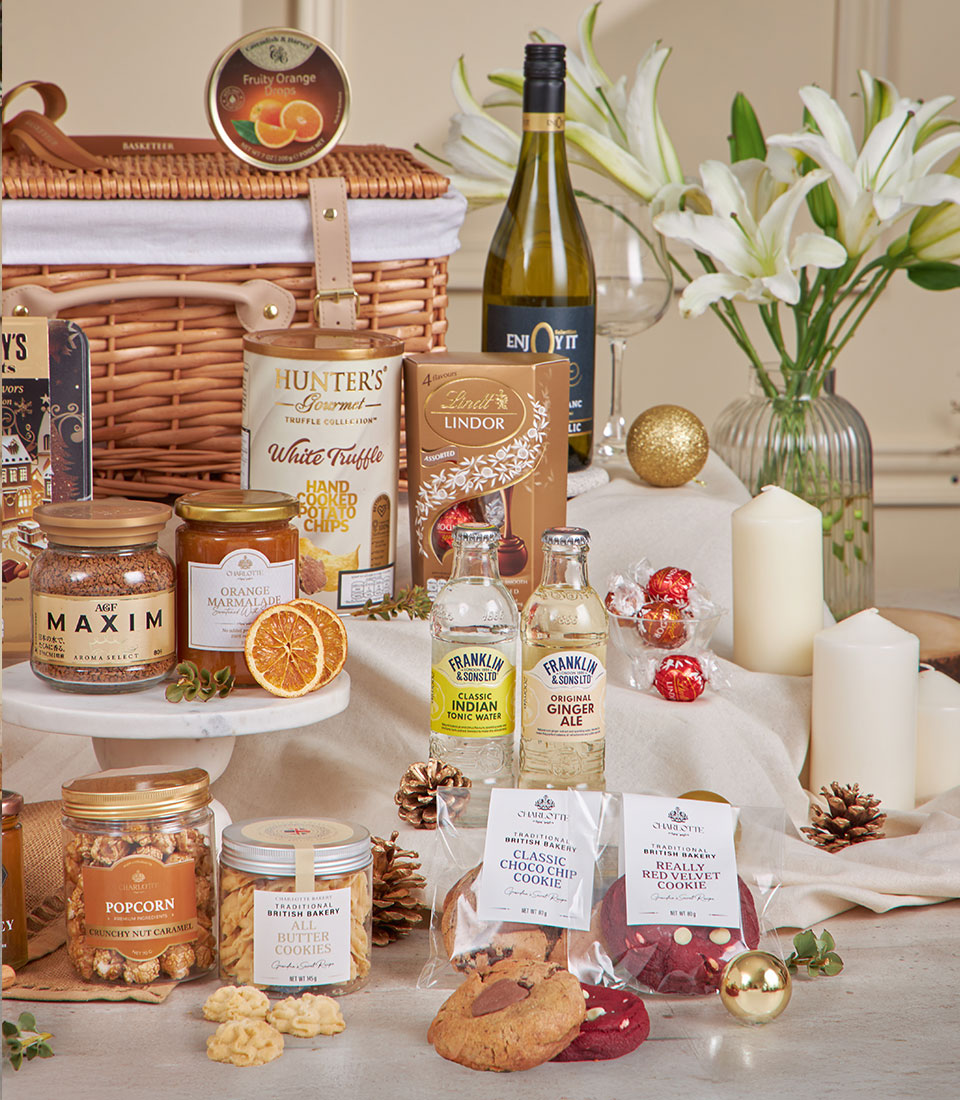 Premium golden gourmet hamper with truffle crisps, Lindt chocolates, marmalade, artisan cookies, and luxury beverages for