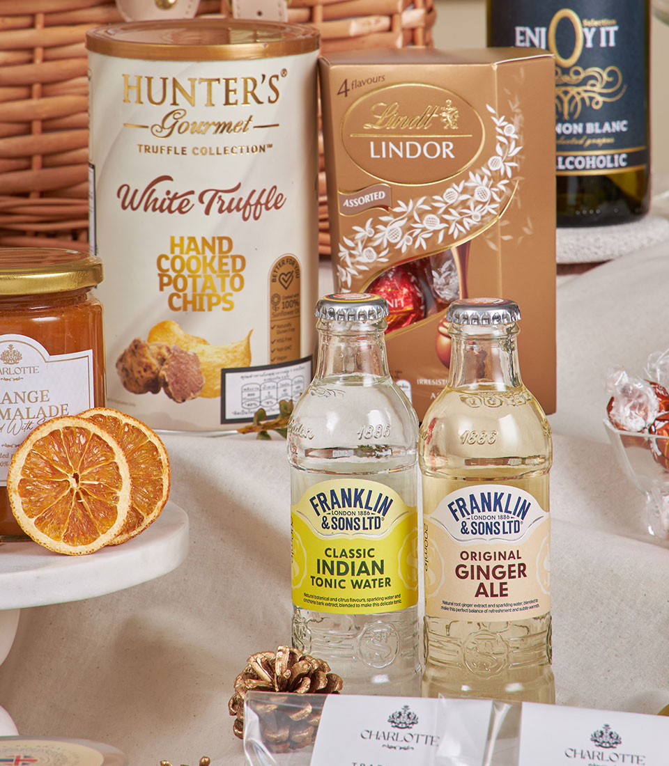 Premium golden gourmet hamper with truffle crisps, Lindor chocolates, artisan beverages and marmalade for New Year gifting
