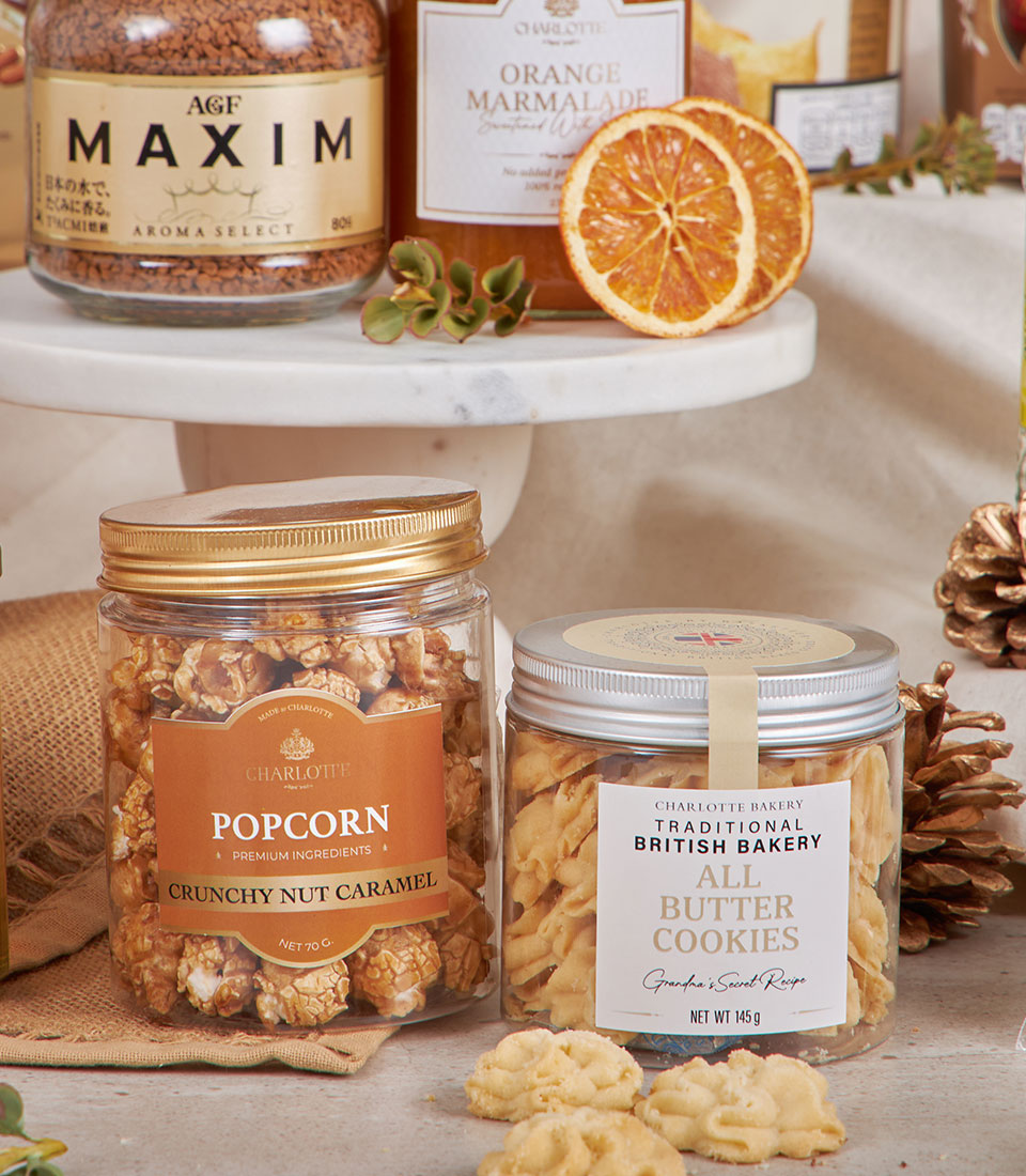 Premium golden gourmet hamper with artisan coffee, marmalade, caramel popcorn, and butter cookies for New Year gifting