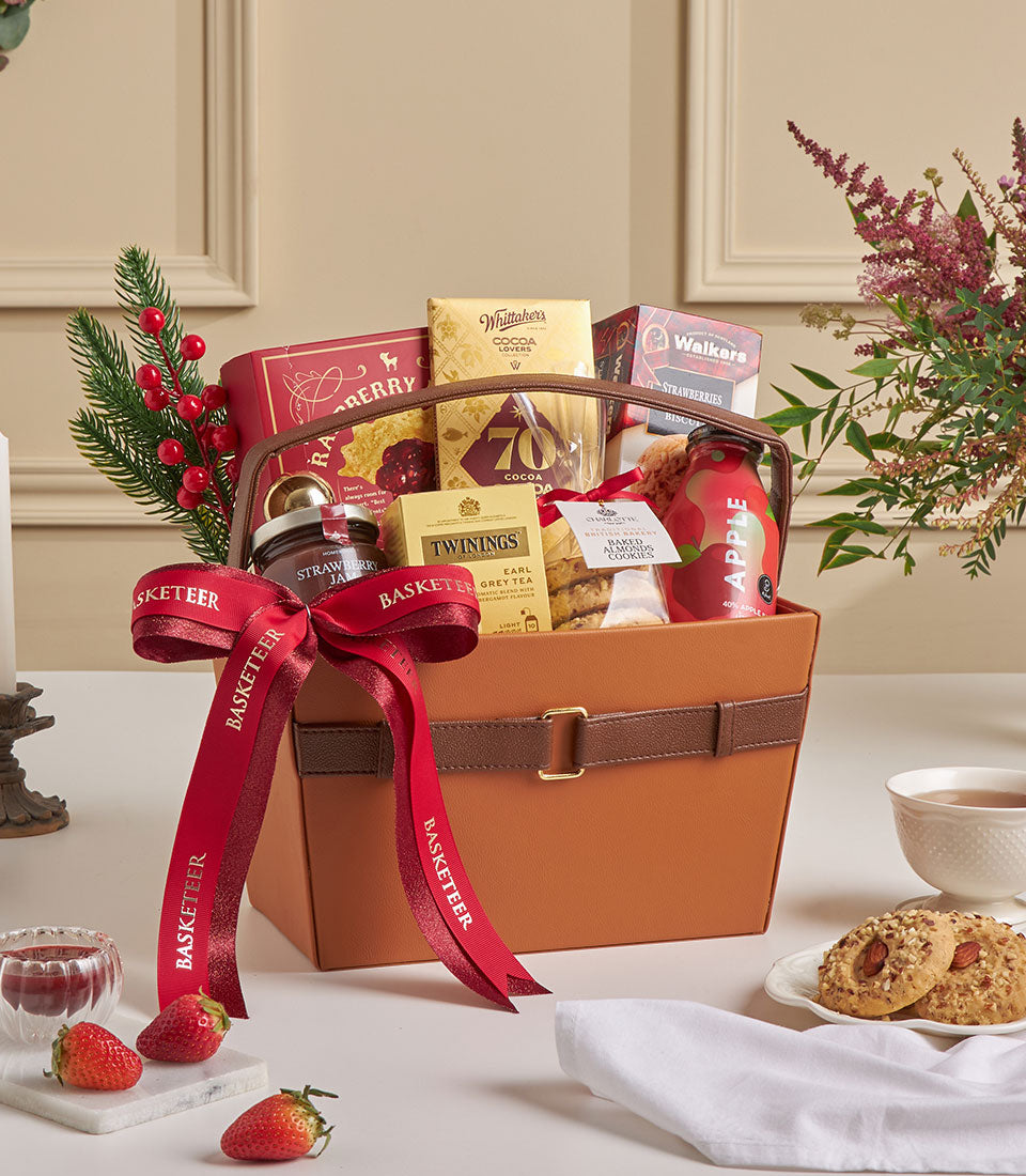 Tan leather luxury gift hamper with raspberry cookies, chocolate, Earl Grey tea, and jam for New Year gifting