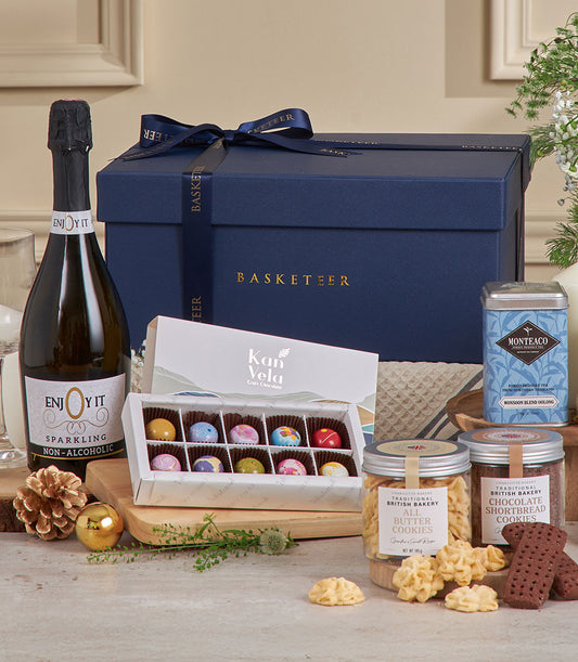 Navy luxury gift box with sparkling beverages, artisan chocolates, and gourmet cookies for New Year celebrations