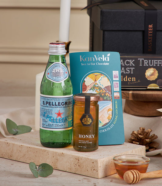 Premium chocolate and tea New Year gift hamper with sparkling water, honey, and artisan treats