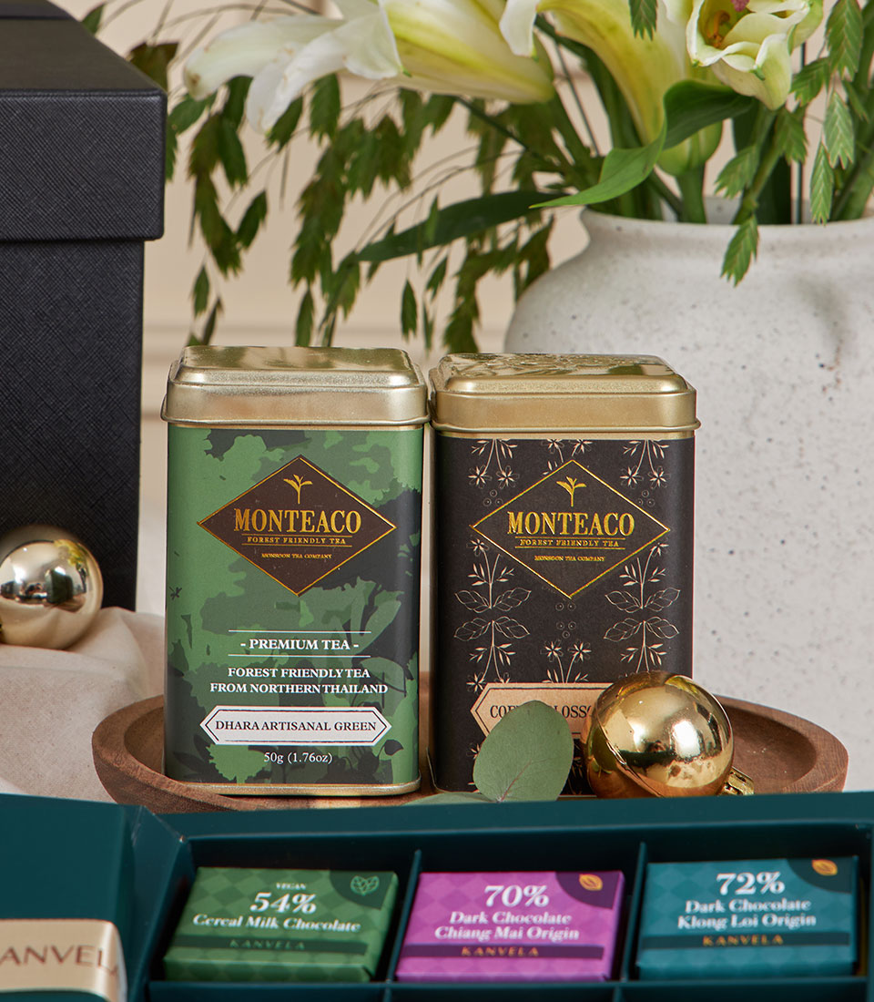 Premium chocolate and artisan tea gift set with gold-lidded tins and handcrafted truffles for New Year gifting