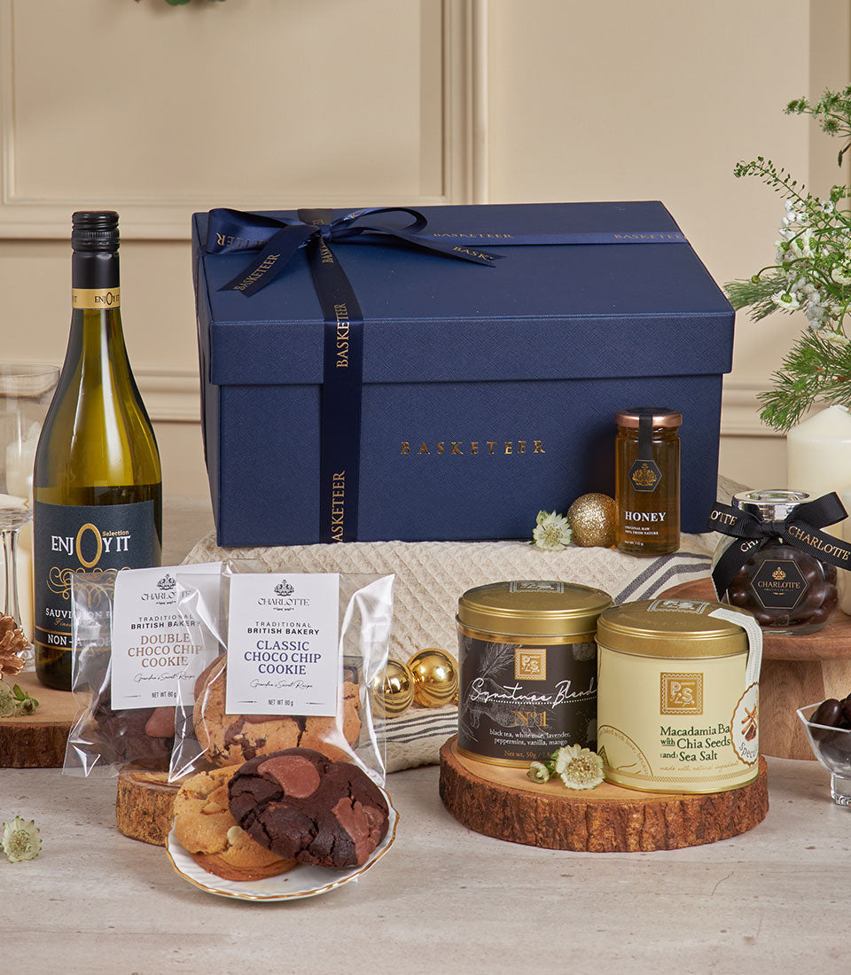 Luxury New Year gift hamper with non-alcoholic white wine, artisan British cookies, honey, and gourmet confections in dark