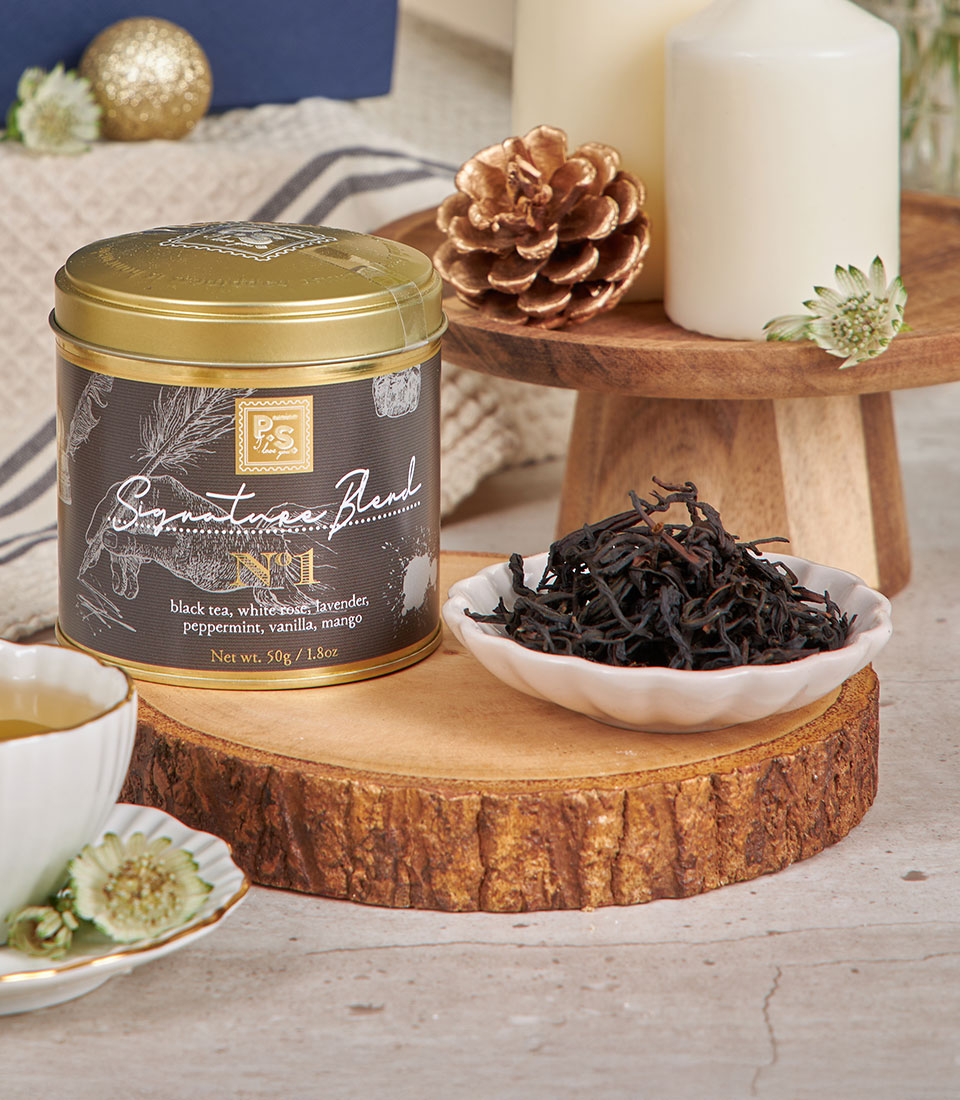 Premium non-alcoholic white wine dessert gift box with luxury tea selection and gold-rimmed teacup for New Year celebrations