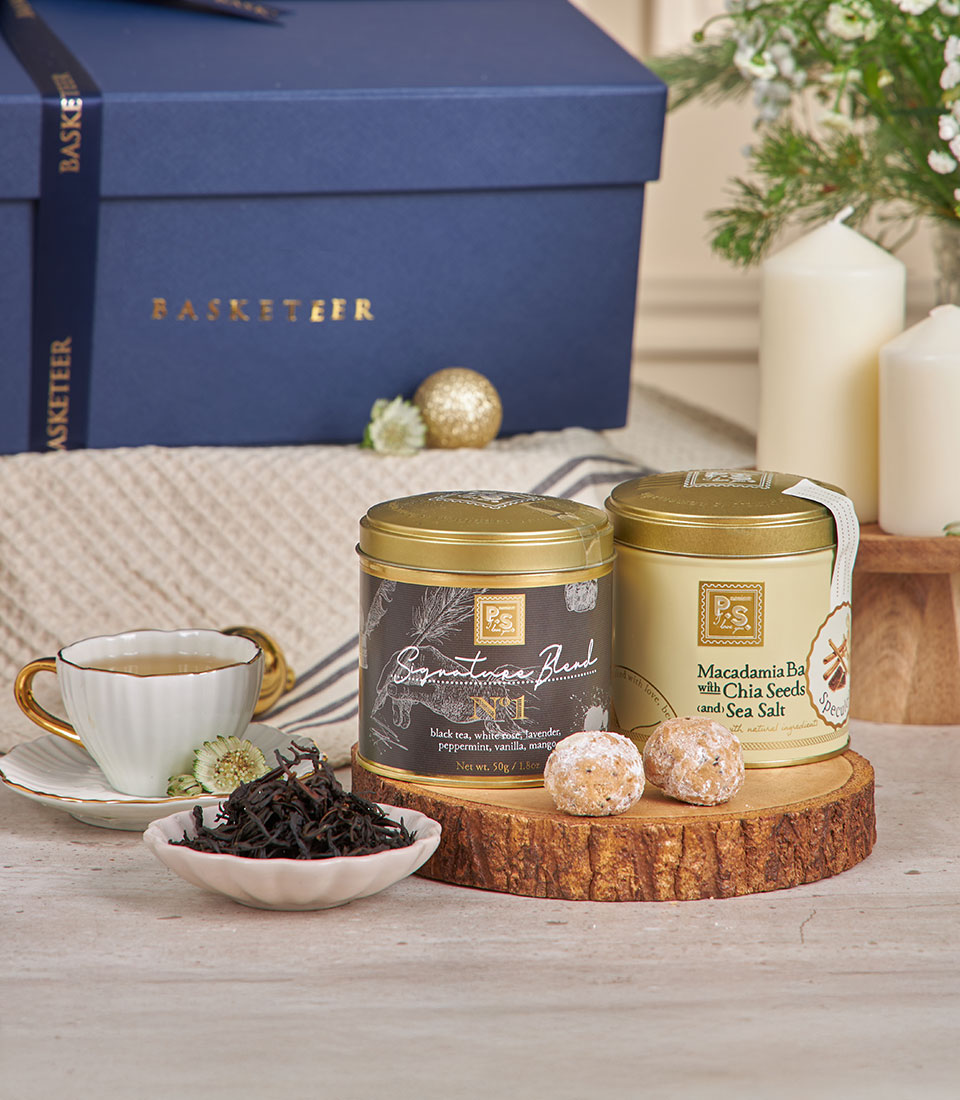 Premium white wine dessert gift box with artisan tea, macadamia snacks, and fresh flowers for New Year celebration