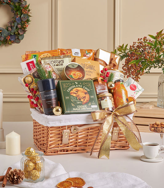 Luxury chocolate and espresso gourmet hamper with truffles, artisan snacks in woven basket with gold ribbon bow