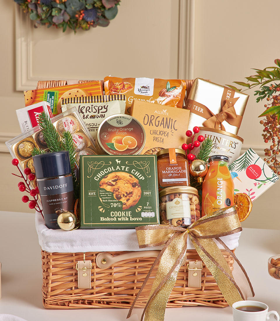 Luxury New Year gift basket with dark wicker, gold ribbon, filled with Davidoff espresso, Ferrero Rocher chocolates, gourmet
