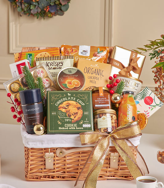 Luxury New Year gift basket with dark wicker, gold ribbon, filled with Davidoff espresso, Ferrero Rocher chocolates, gourmet