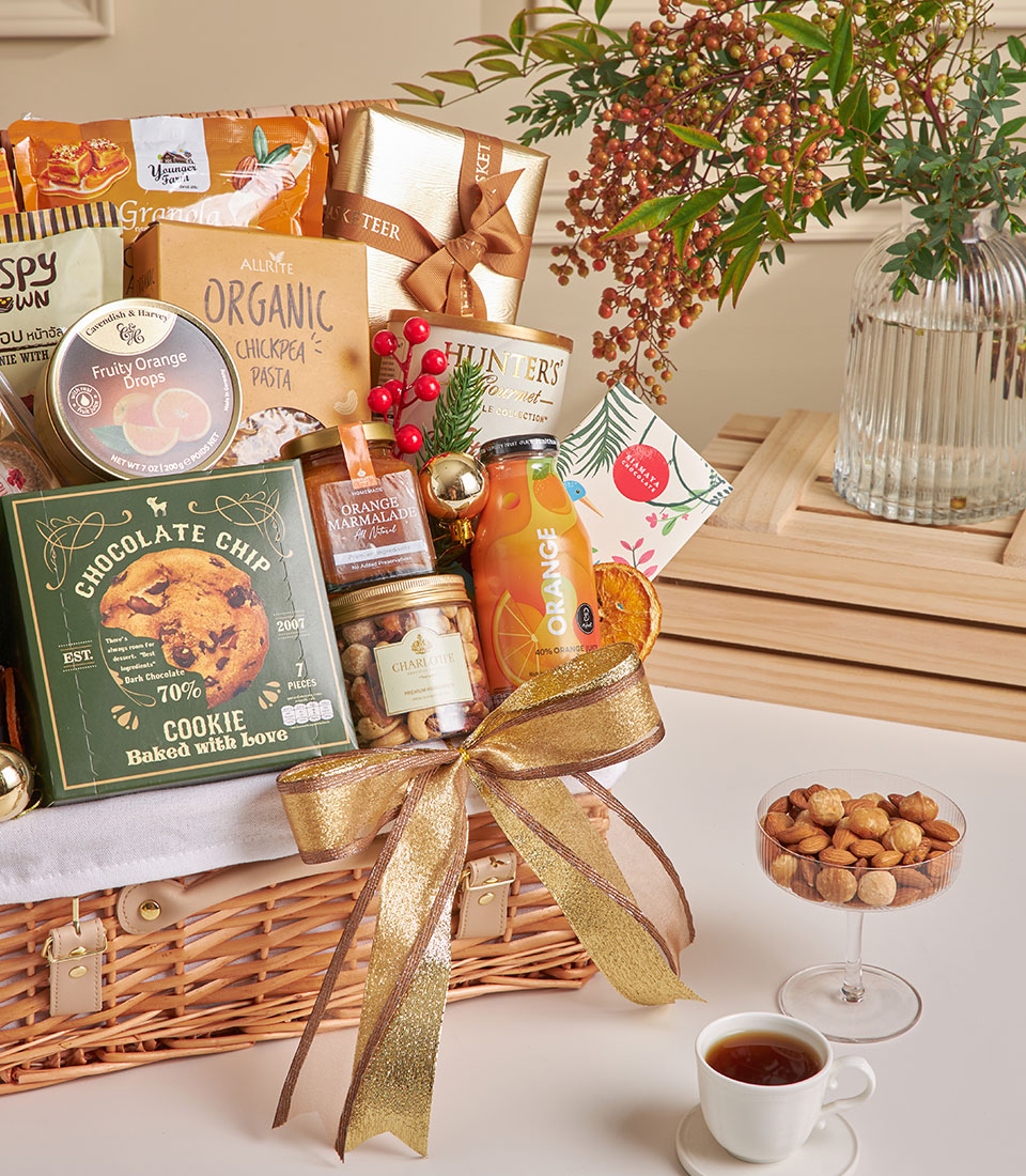 Luxe wicker gift basket with chocolates, truffles, espresso, gourmet snacks and gold ribbon for New Year celebrations