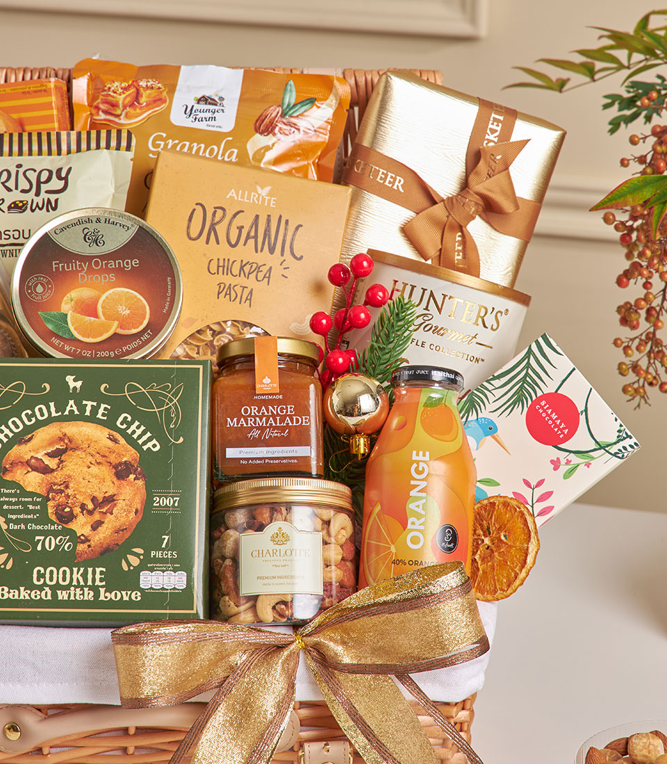Luxury gourmet hamper with chocolate, truffles, espresso, granola, and festive gold ribbon for New Year gifting