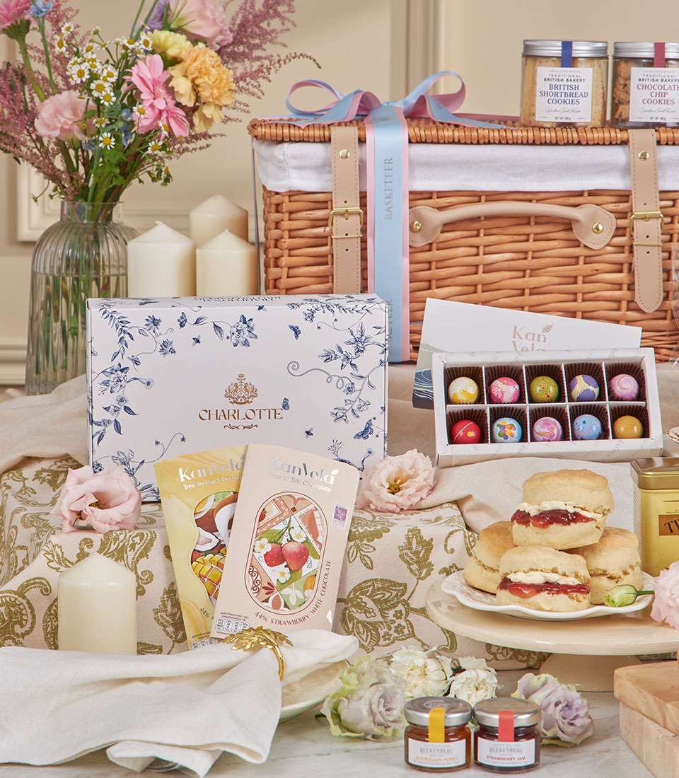 Luxury afternoon tea hamper with Charlotte Bakery shortbread, scones, artisan chocolates, and honey in wicker basket with