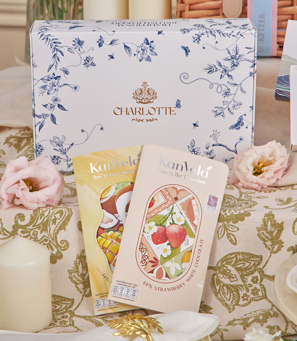 Charlotte Luxury Afternoon Tea Grand Hamper with artisan chocolates, premium tea collection, pink flowers, and elegant table