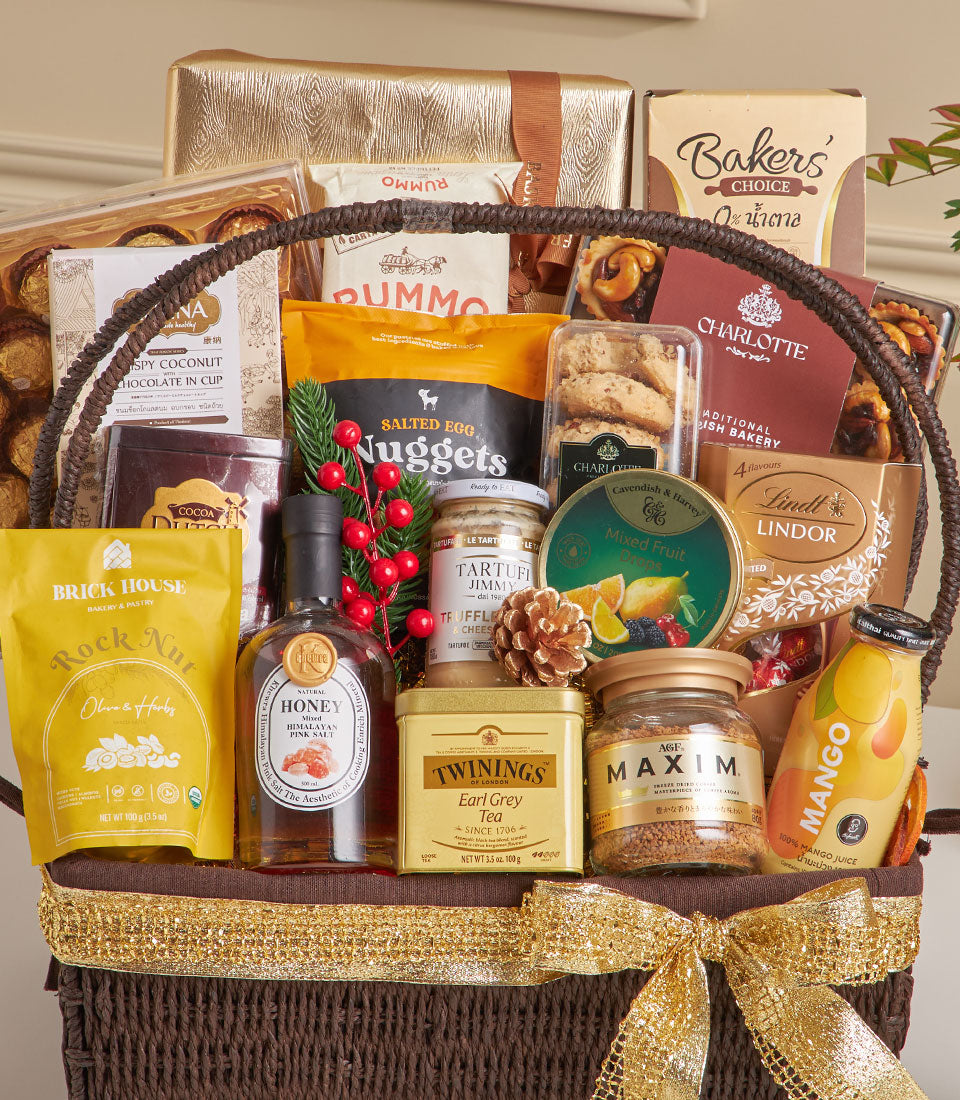 Dark brown woven gourmet hamper with gold ribbon, luxury chocolates, fine foods, and specialty teas for New Year gifting