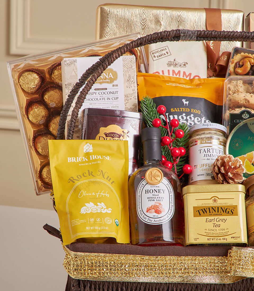 Luxury dark wicker gift basket with gold ribbon filled with premium chocolates, gourmet foods and fine tea for New Year