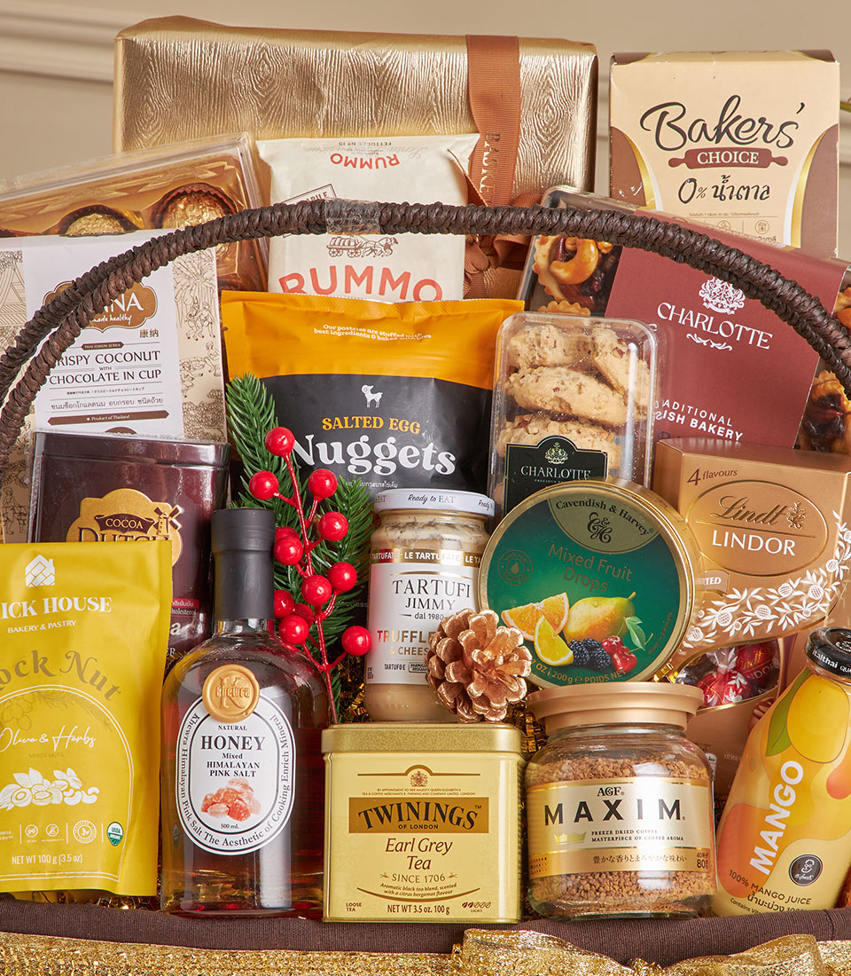 Luxury gourmet gift hamper with premium chocolates, truffle cheese, and artisan foods in woven basket for New Year gifting