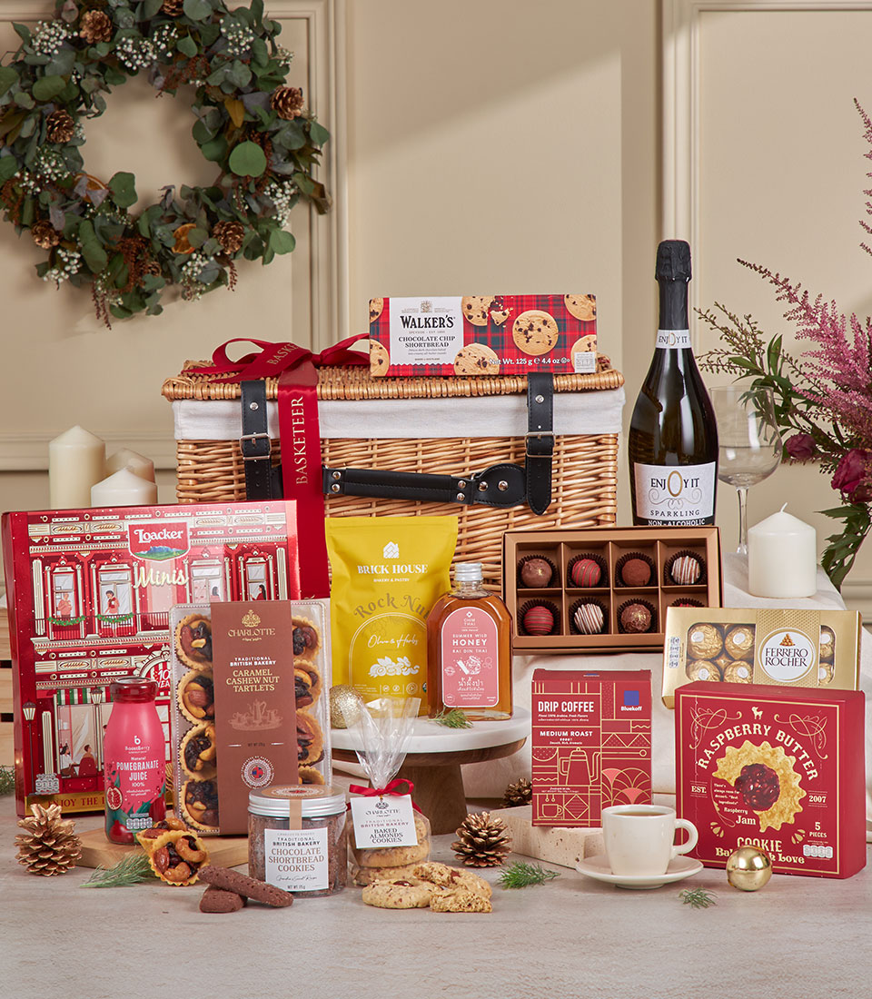 Luxury wicker hamper filled with sparkling beverages, gourmet chocolates, and artisan treats for New Year gifting