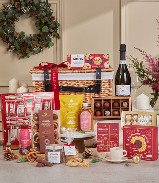 Luxury wicker hamper filled with sparkling beverages, gourmet chocolates, and artisan treats for New Year gifting