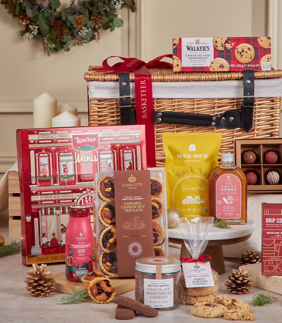 Sparkling chocolate and gourmet indulgence hamper in wicker basket with shortbread, honey, and festive truffles for New Year