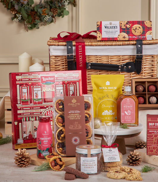 Sparkling chocolate and gourmet indulgence hamper in wicker basket with shortbread, honey, and festive truffles for New Year