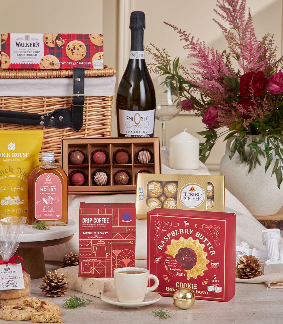 Luxury New Year gift hamper with sparkling beverage, gourmet chocolates, artisan cookies, and fresh pink roses