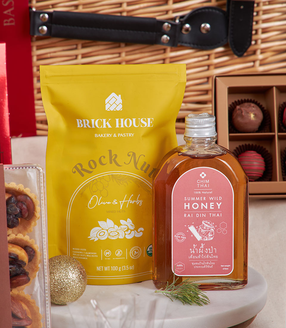 Luxury New Year gift hamper with gourmet mixed nuts, raw honey, chocolate truffles, and festive gold accents