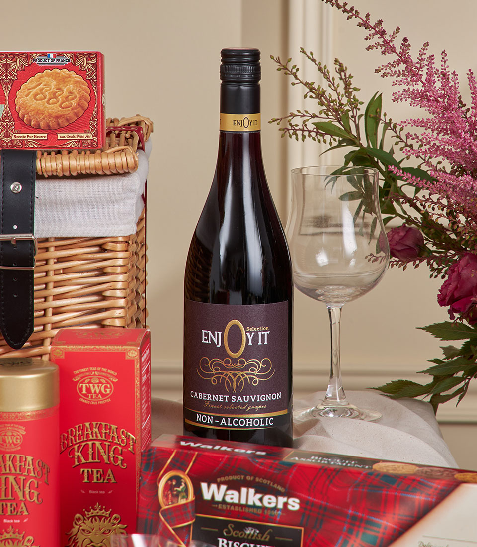 Premium red gourmet hamper with Cabernet Sauvignon, French biscuits, tea, and fresh flowers for New Year celebrations