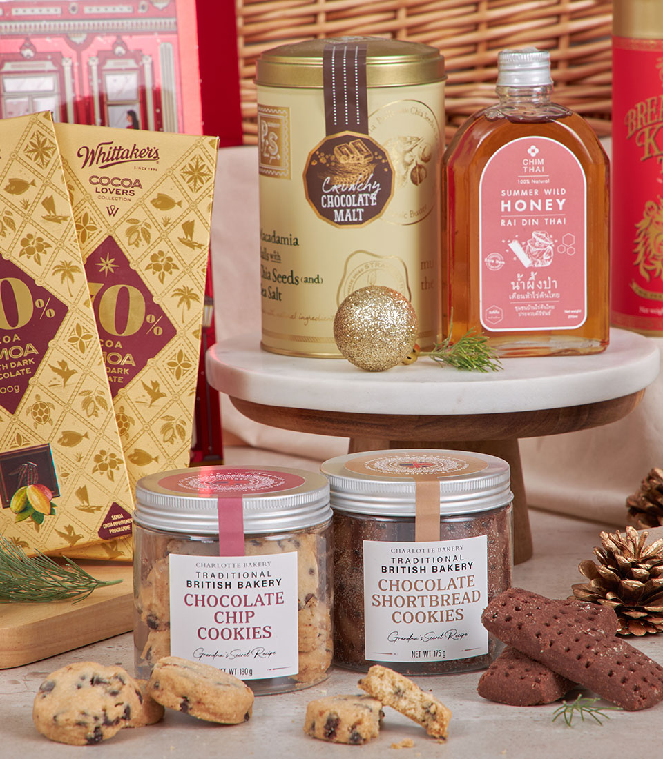 Luxury red gourmet hamper with Charlotte Bakery cookies, chocolate malt tin, wild honey, and artisan chocolates for New Year