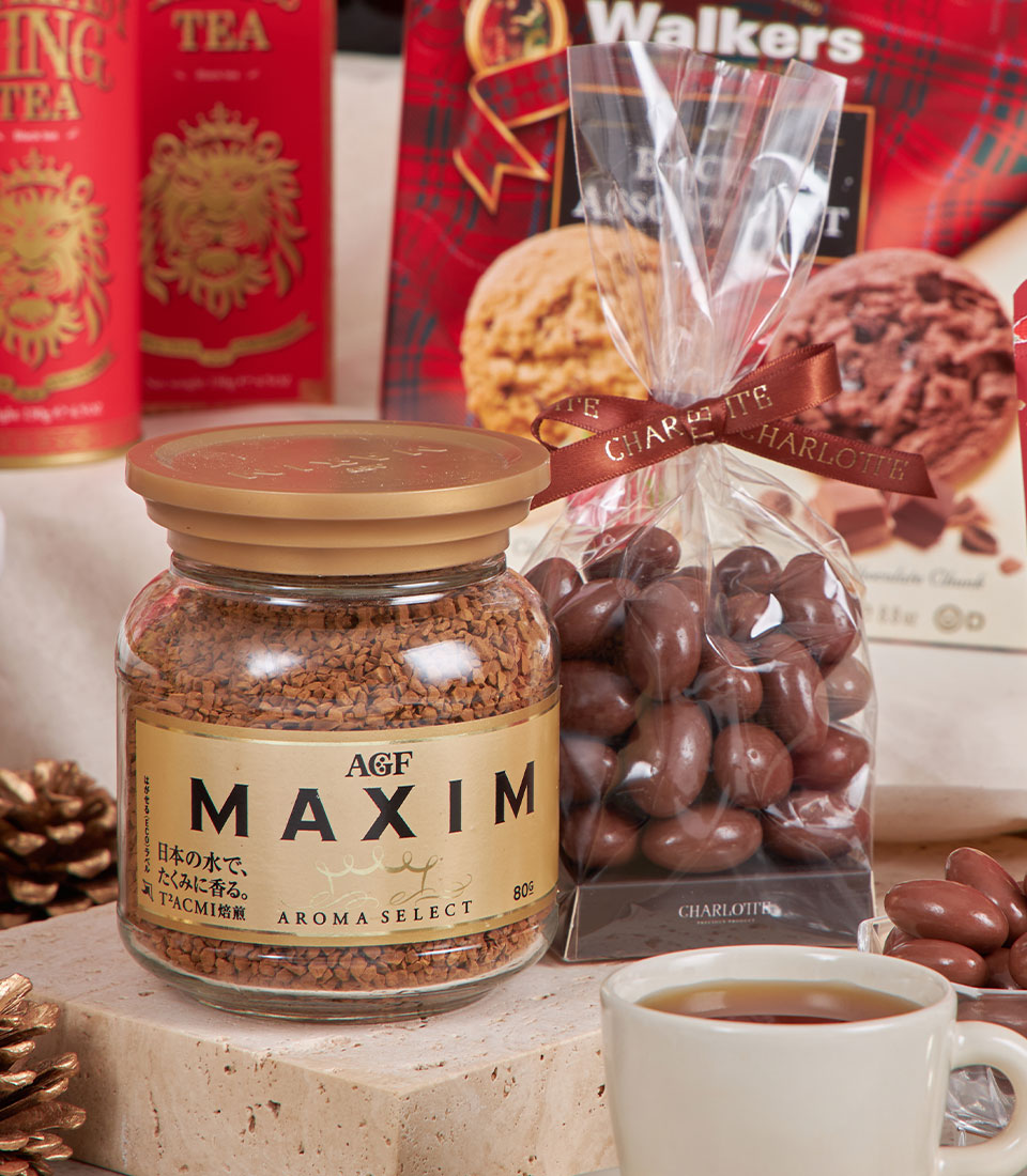 Luxury red gourmet hamper with premium coffee, chocolate almonds, tea, and festive treats for New Year gifting
