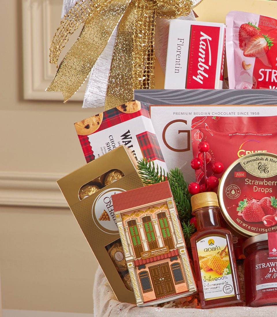 Luxury gourmet hamper with gold chocolates, artisan cookies, honey, and jam in woven basket with festive gold bow