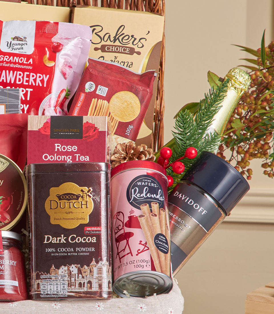 Deluxe gourmet hamper with chocolate, premium tea, crackers and artisan snacks in woven basket for New Year celebrations