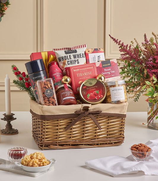 Woven wicker hamper with gourmet treats, bird's nest, tiramisu, cookies, tea, and Davidoff fragrance for New Year gifting