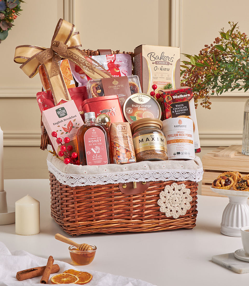 Woven wicker gift basket with almond crackers, gourmet treats, tea, honey and coffee for New Year gifting