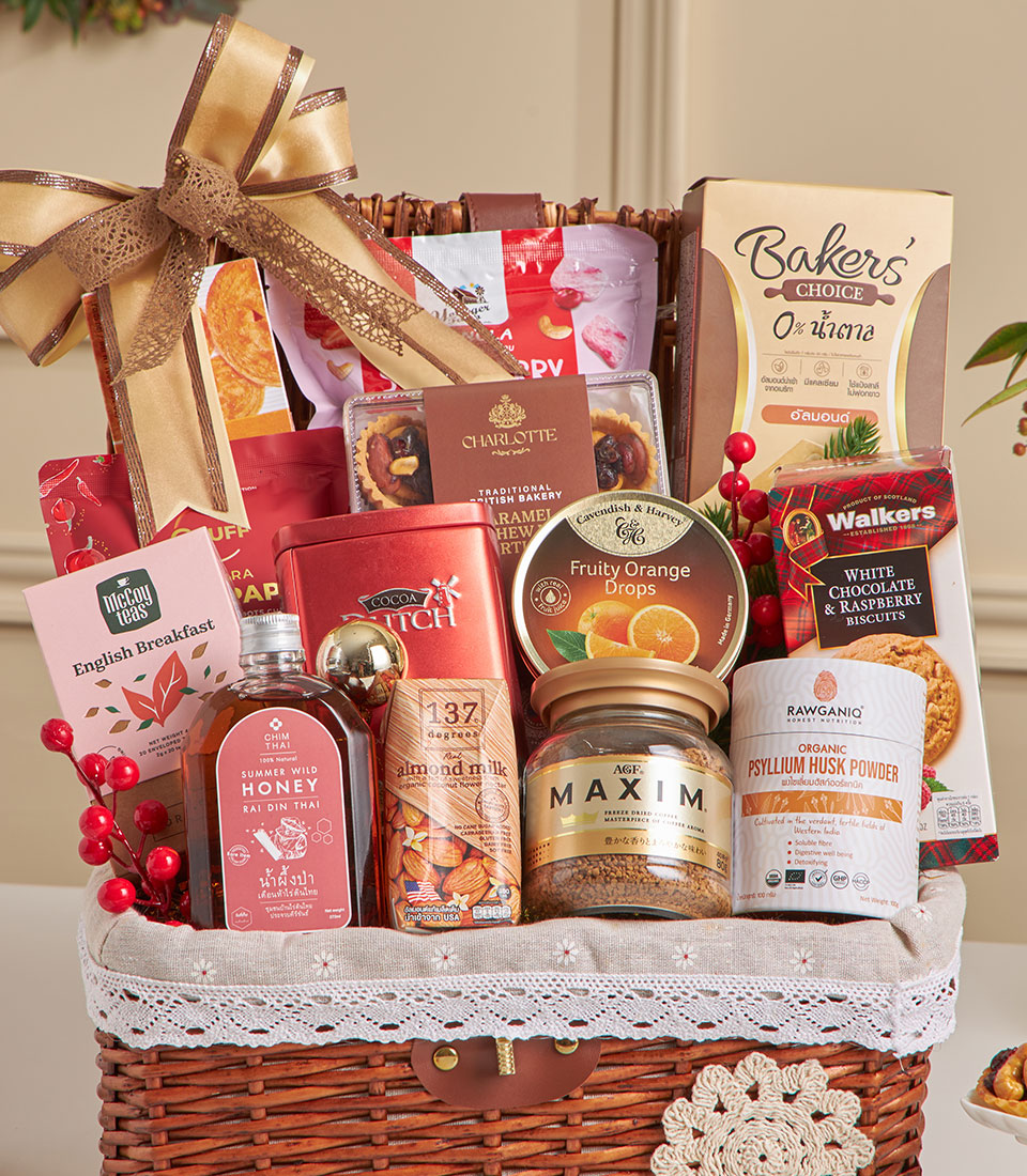 Woven wicker hamper with almond crackers, gourmet treats, honey, tea, and Charlotte bakery tarts—New Year gift basket