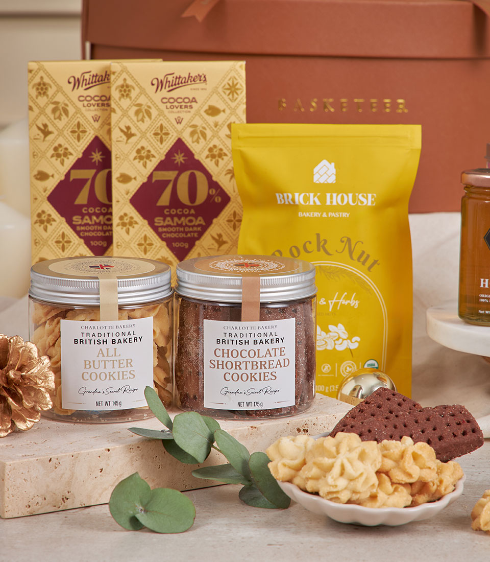 Brown luxury gourmet gift basket with artisan cookies, chocolate, and pastries for New Year
