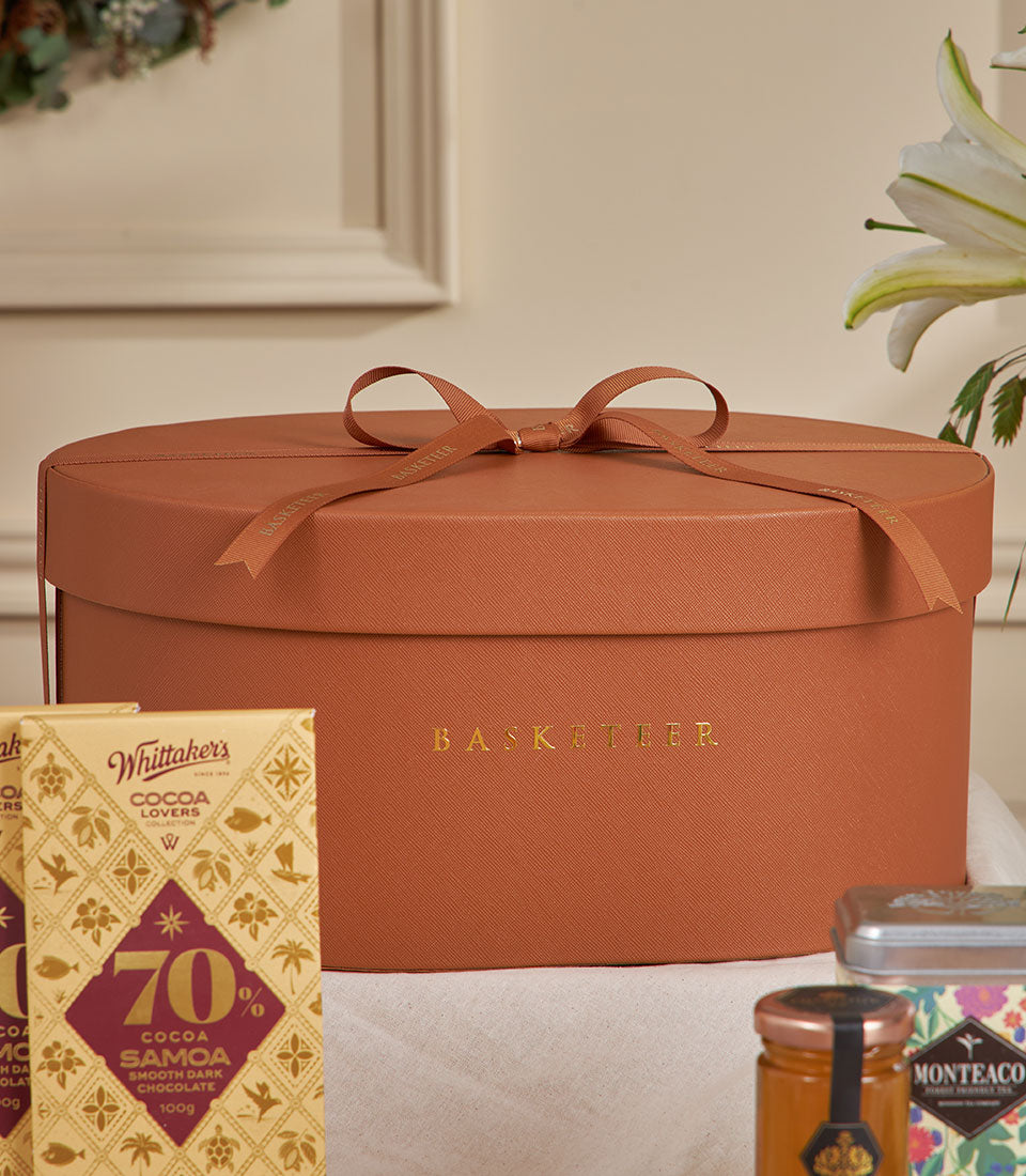 Brown terracotta luxury gift box with Whittaker's chocolate and gourmet treats for New Year gifting