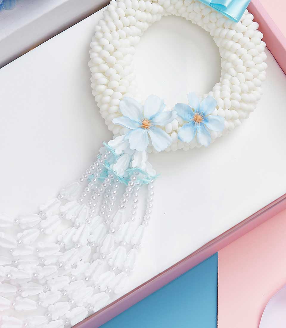 White Phuang Malai garland with blue flowers and pearl strands for Mother's Day