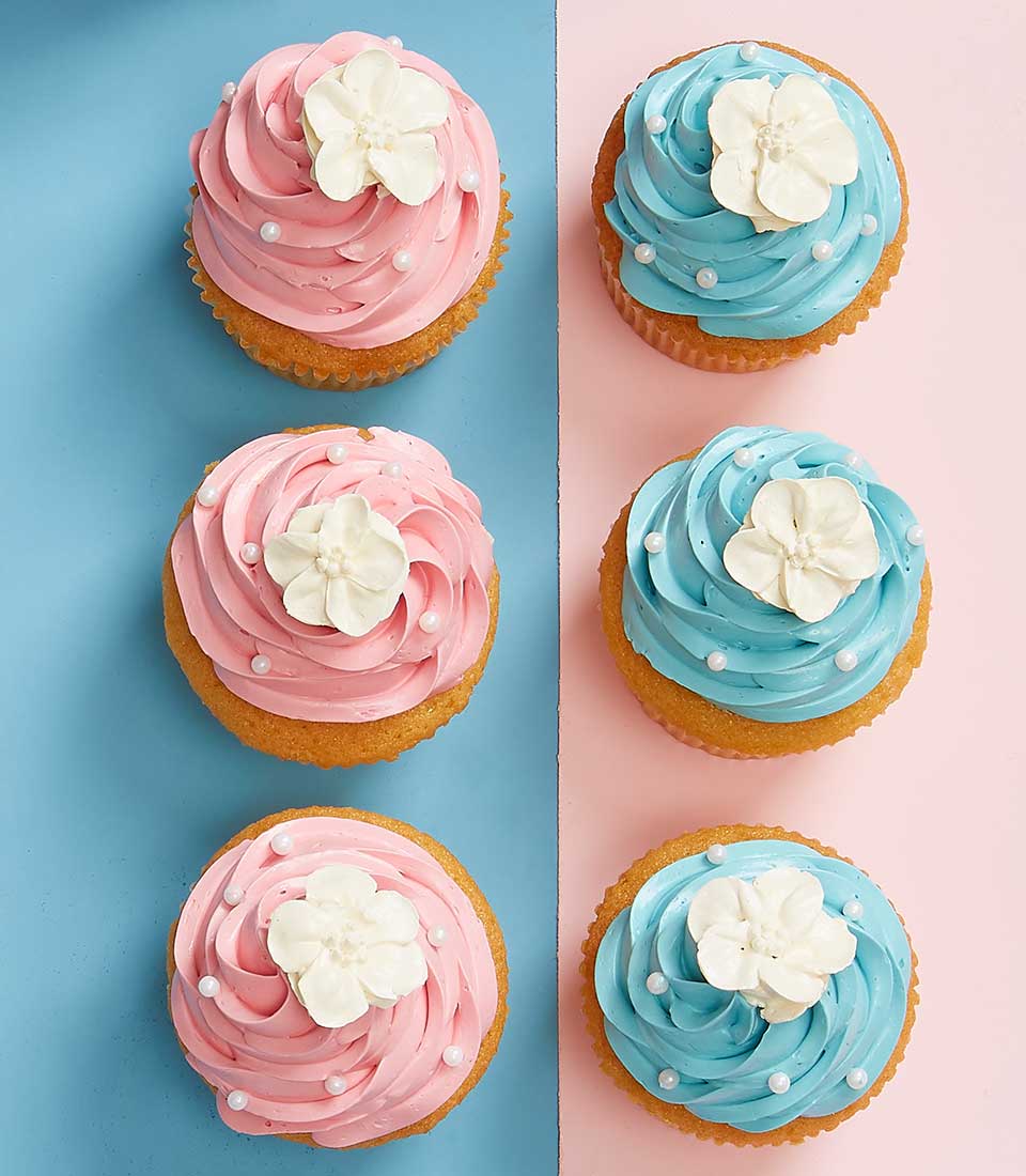 Sweet Jasmine Bliss cupcakes with pink and blue frosting, white flower toppers, and pearl sprinkles for Mother's Day