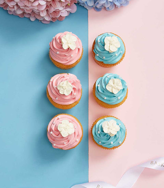 Sweet Jasmine Bliss cupcakes with pink and blue frosting, white flower toppers, and pearl sprinkles for Mother's Day